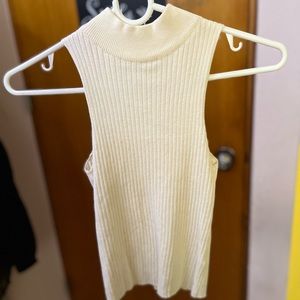 White/ivory sleeveless high neck top.